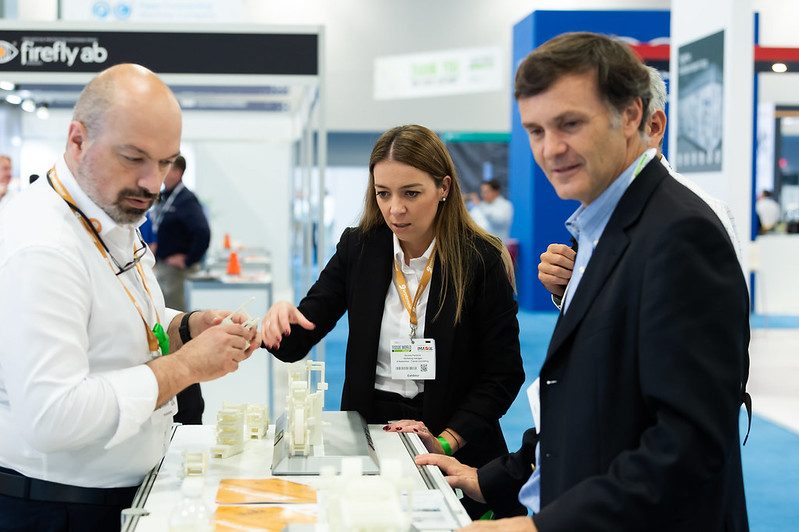 Tissue World visitors talking with an exhibitor about new products
